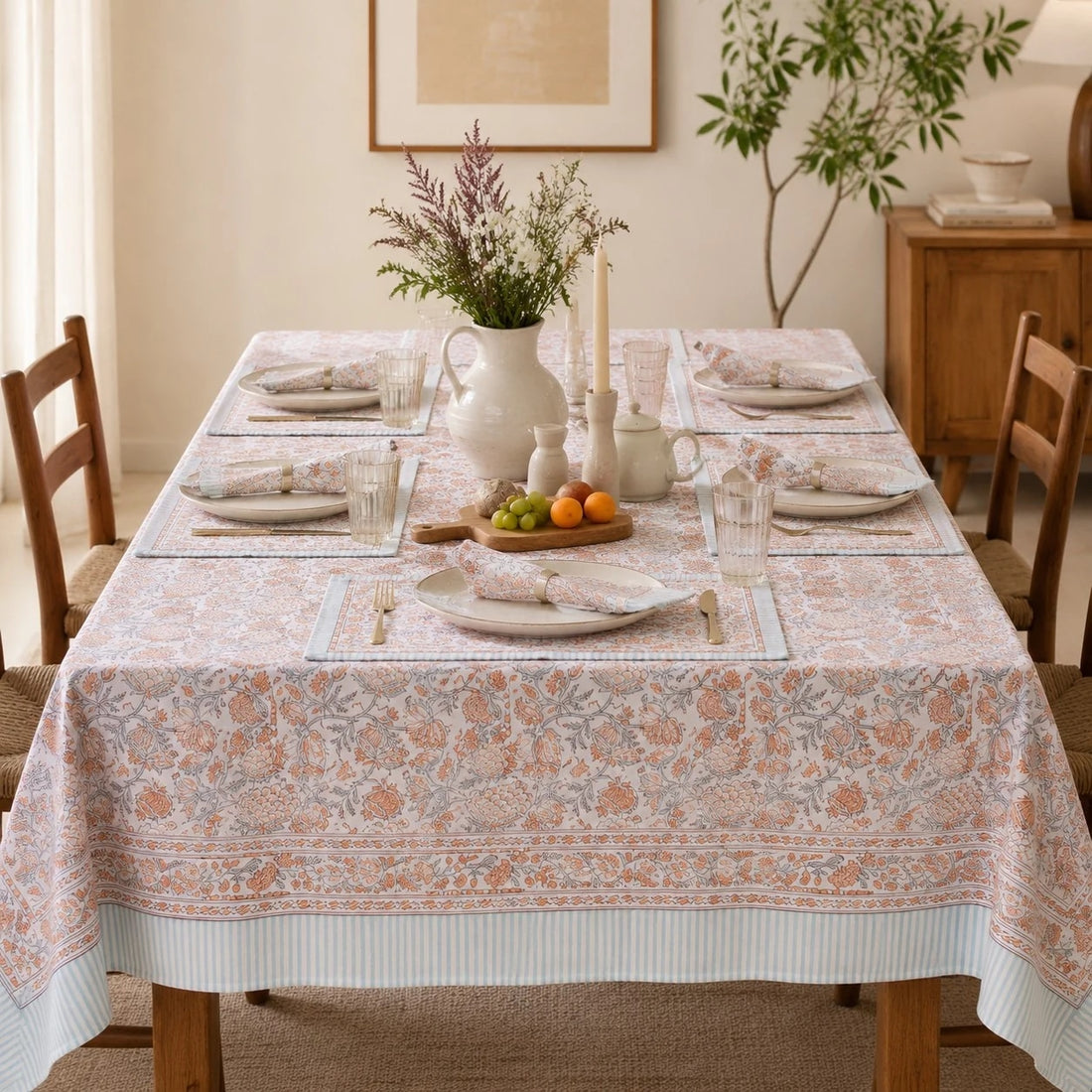 Mist blue floral tablecloth styled in a bright dining room