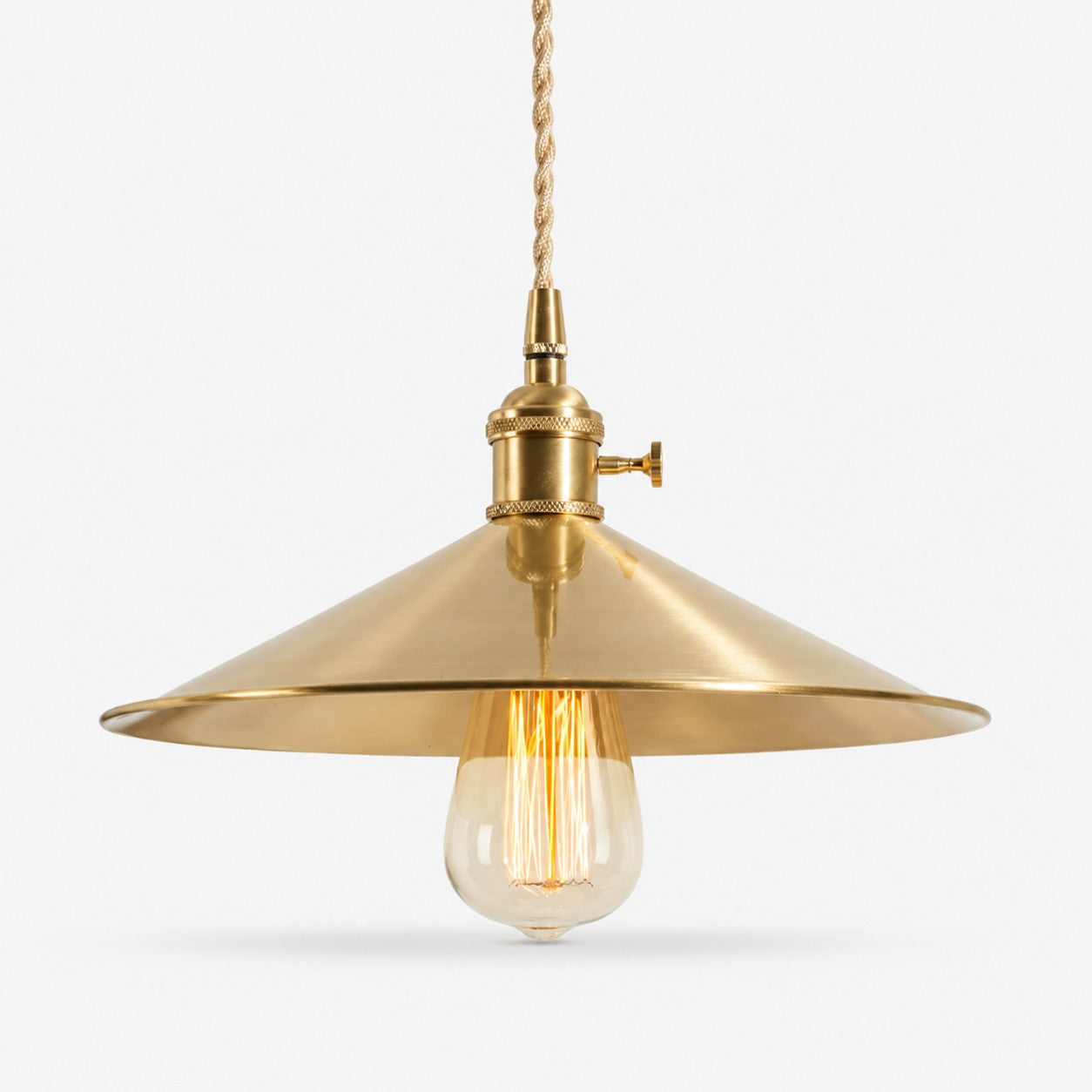 Wide disc copper pendant light on a white background