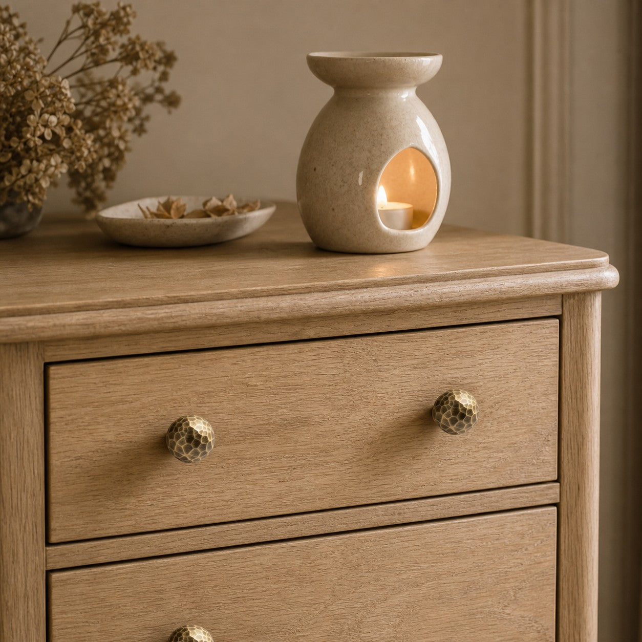 Pair of hammered antique brass knobs on a drawer front