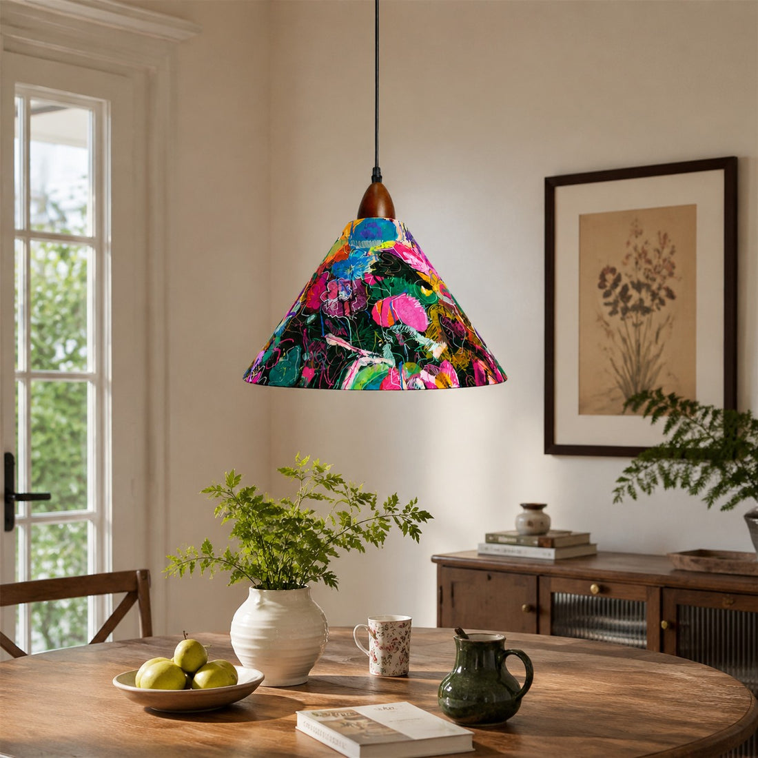 Painted floral pendant above rustic oval dining table with green plants