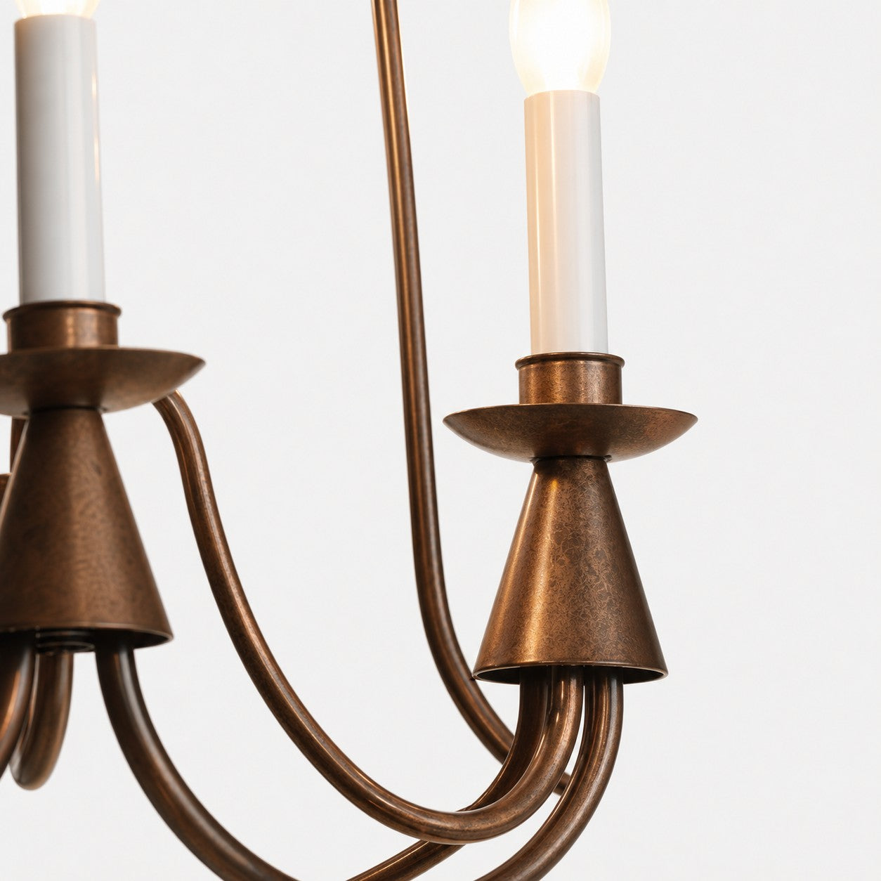 Detailed view of antique bronze chandelier candle socket and arm finish
