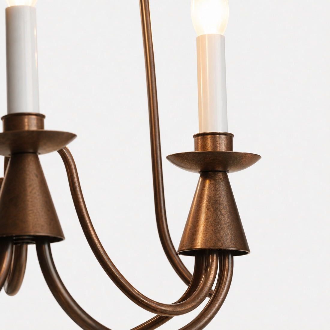 Detailed view of antique bronze chandelier candle socket and arm finish