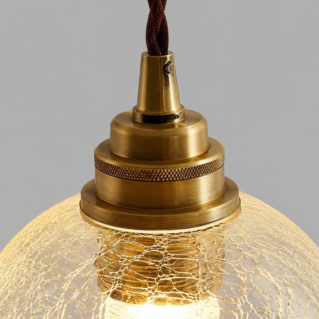 brass socket hardware and clear glass pendant shade detail