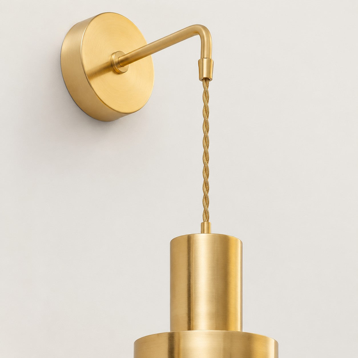 Chain suspended brass wall sconce with round wall base