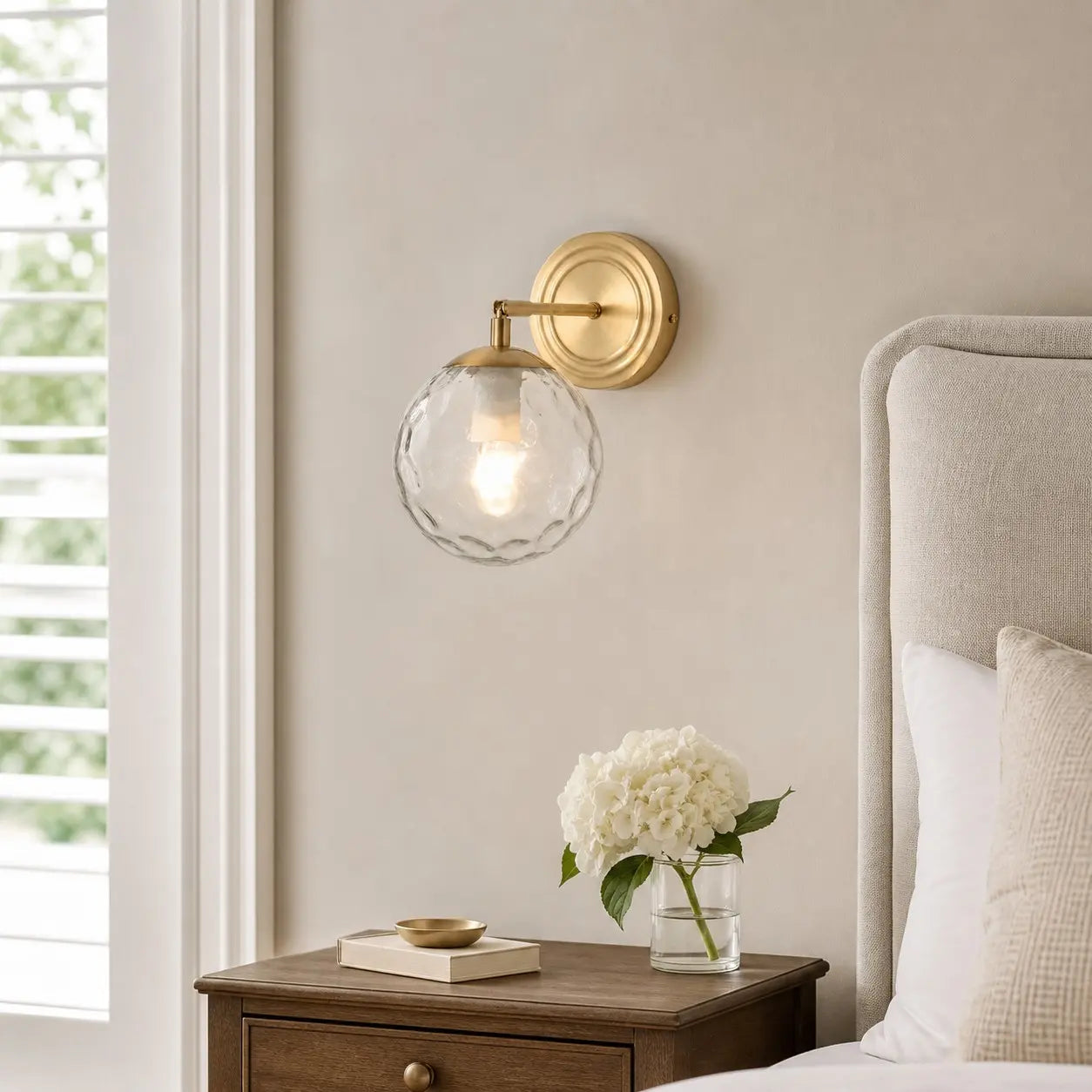 Rippled glass wall lamp in a warm neutral bedroom