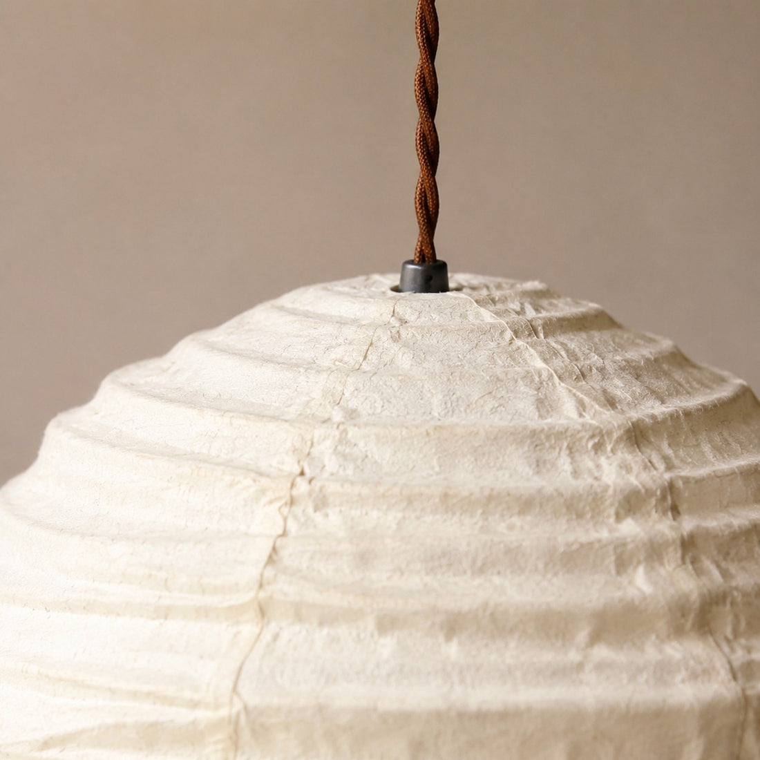 Close view of pendant cord and upper linen shade connection