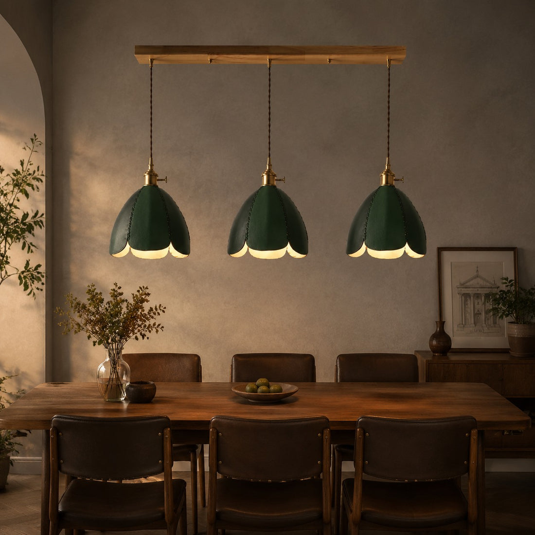 Three green leather pendant lights above a dining table