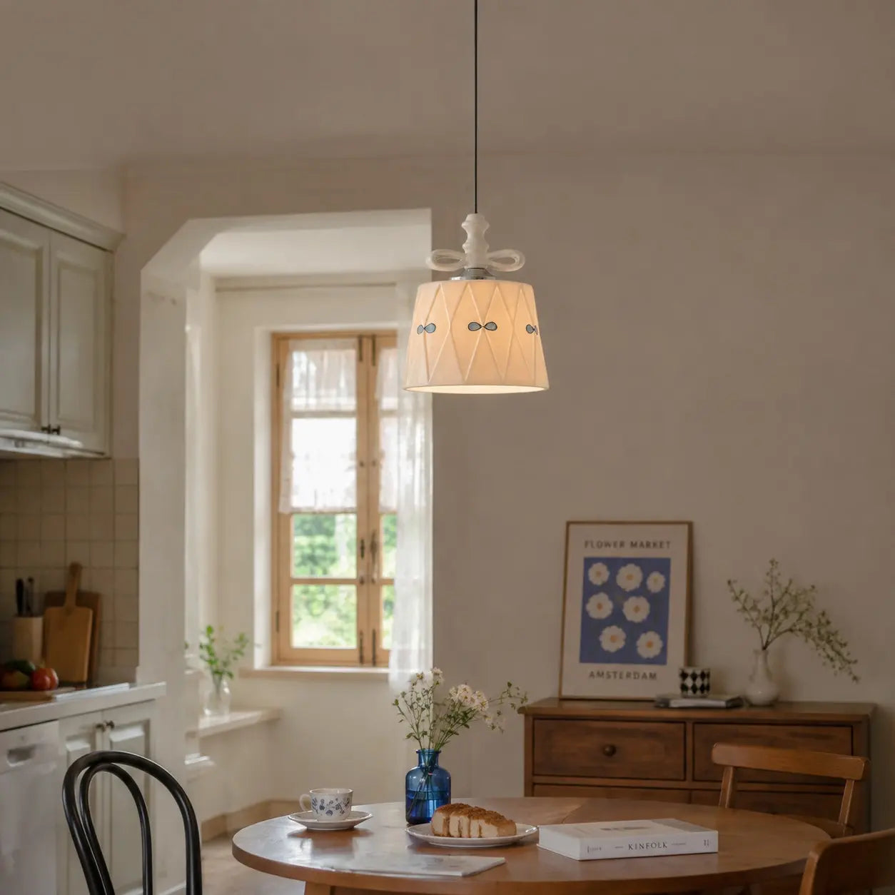 Ceramic bow pendant light in a softly lit dining space