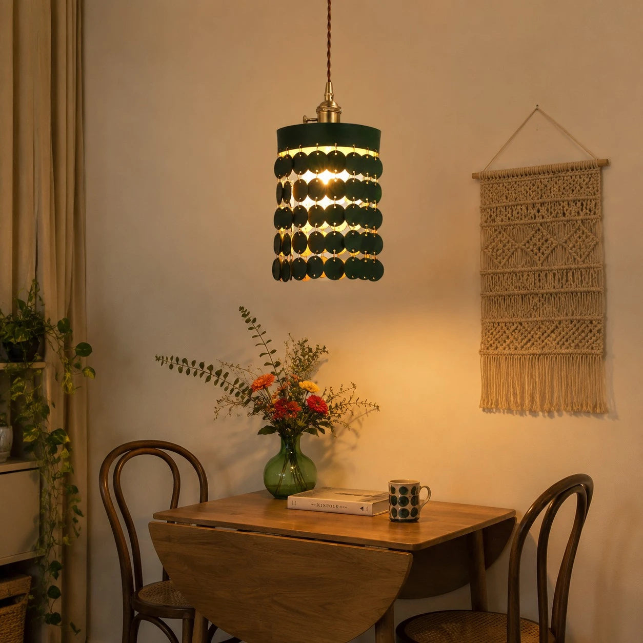 Green leather pendant light above a small dining table