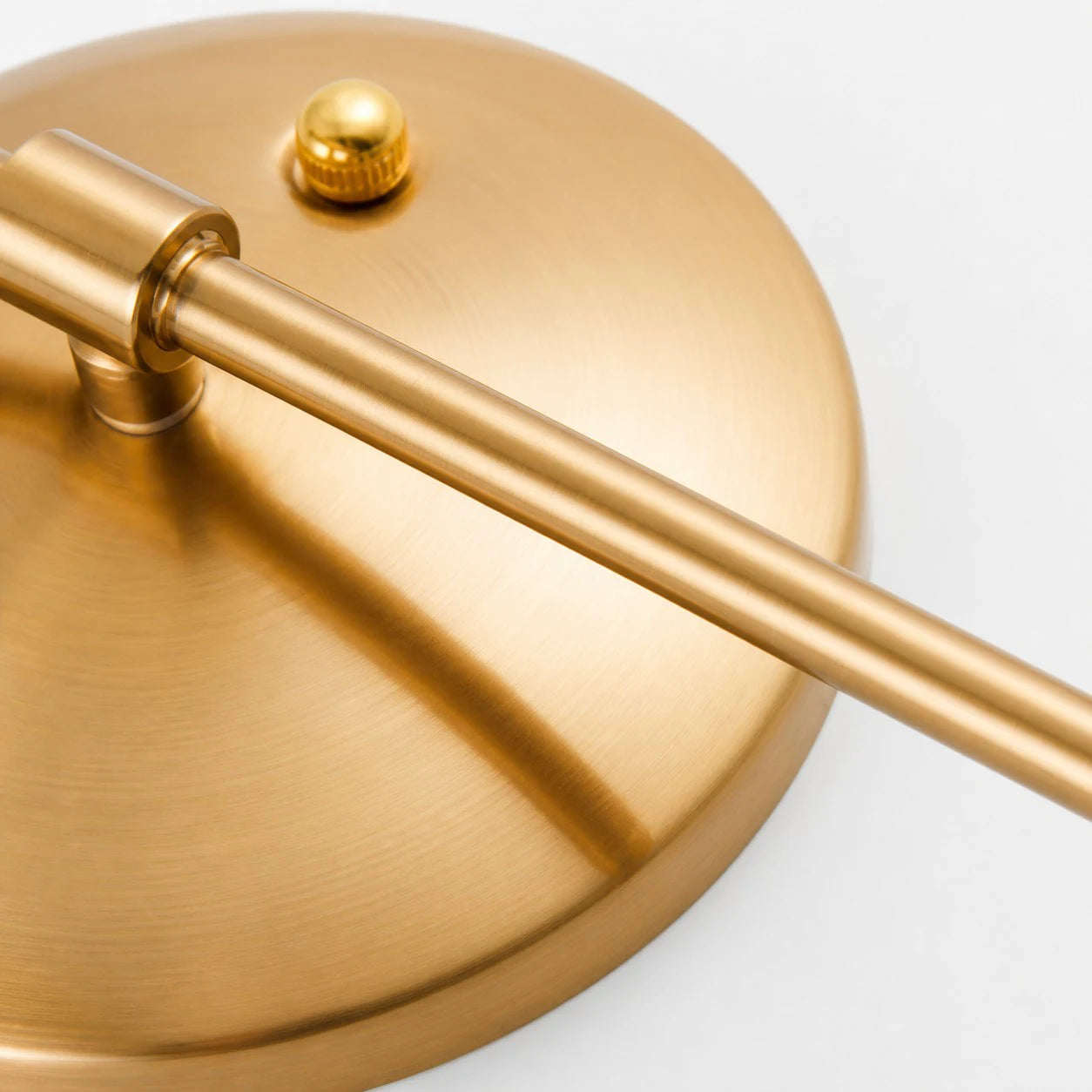 Brushed gold wall plate and curved arm detail