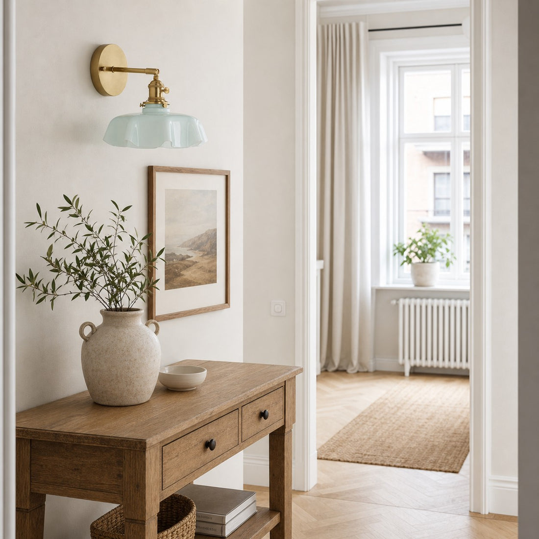 Blue milk glass brass wall sconce above an entry console