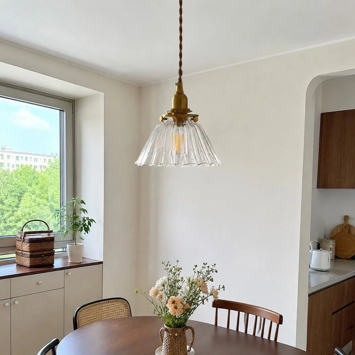 Clear ribbed pendant near a window corner