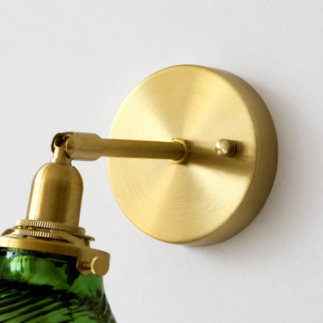 Brass round backplate and wall arm detail