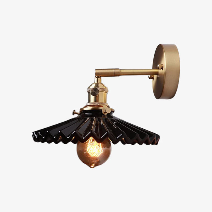 Black pleated ceramic wall sconce with metal arm and round backplate
