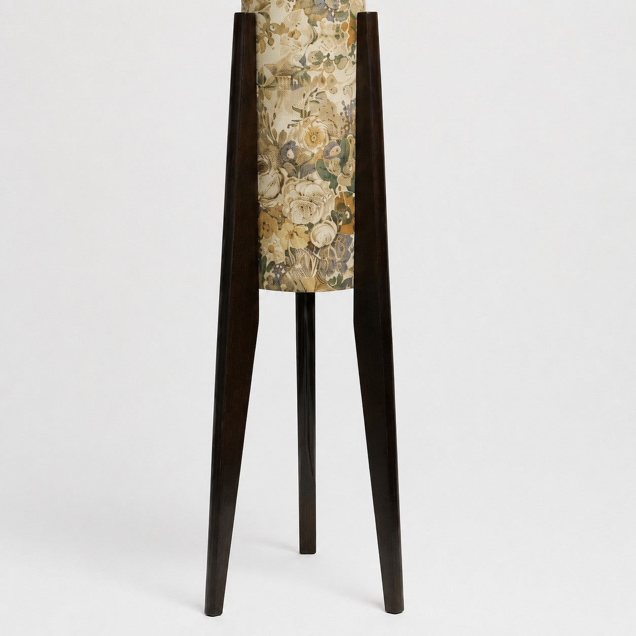 Close-up of dark solid wood tripod legs and central floor lamp stem
