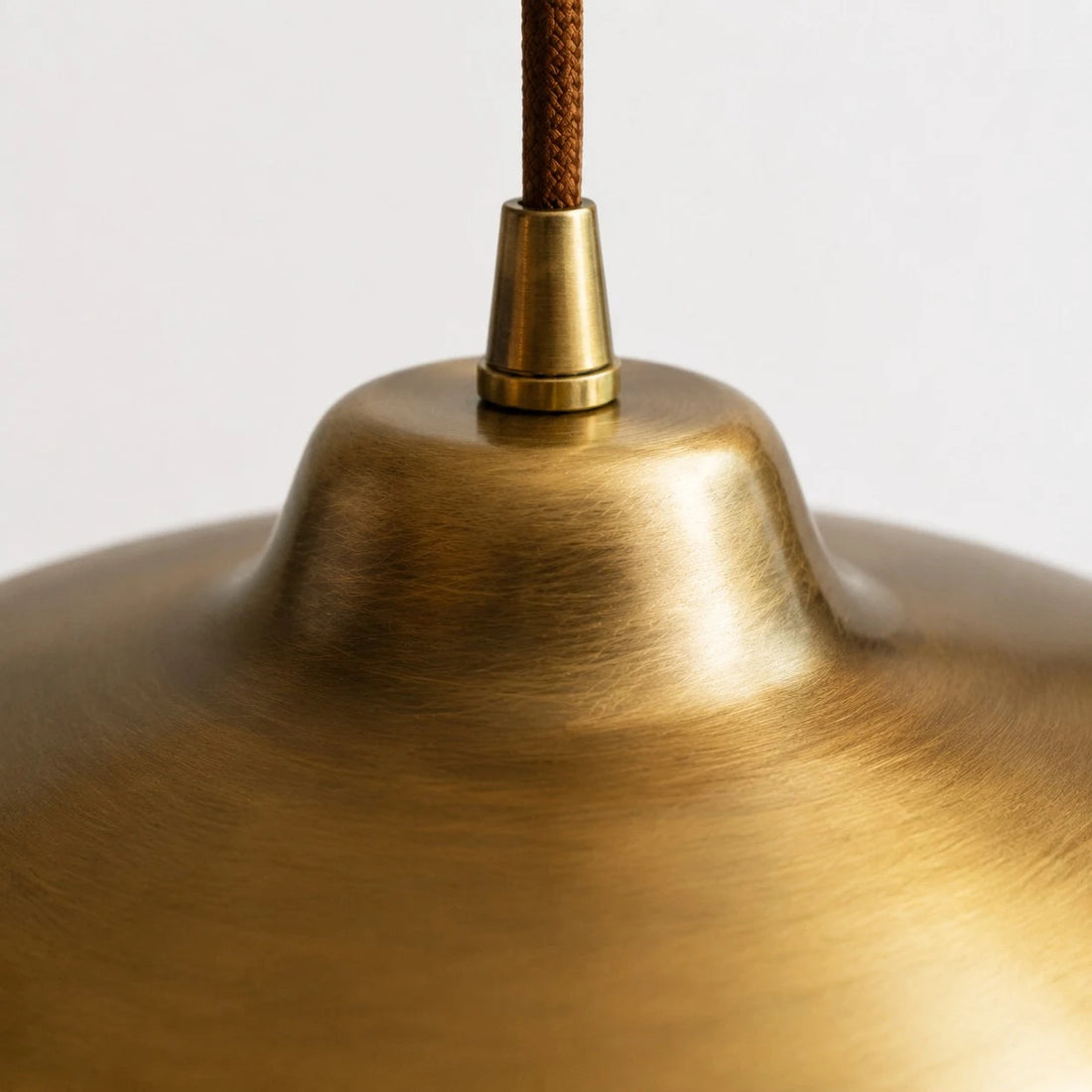 Close view of the antique brass surface and cord connection