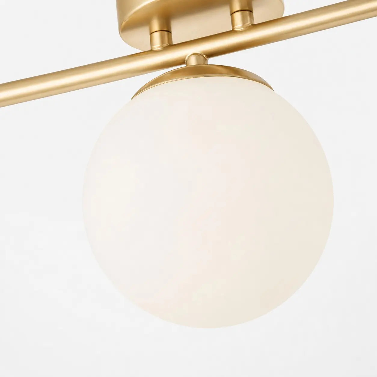 Milk glass shade and gold frame connection detail