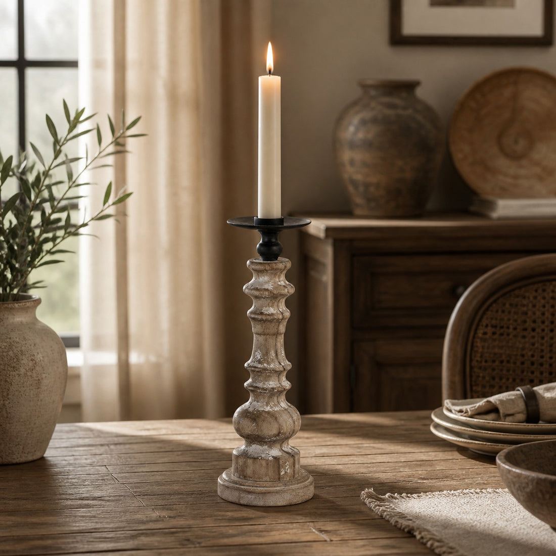Tall turned wood candlestick styled on a dining table
