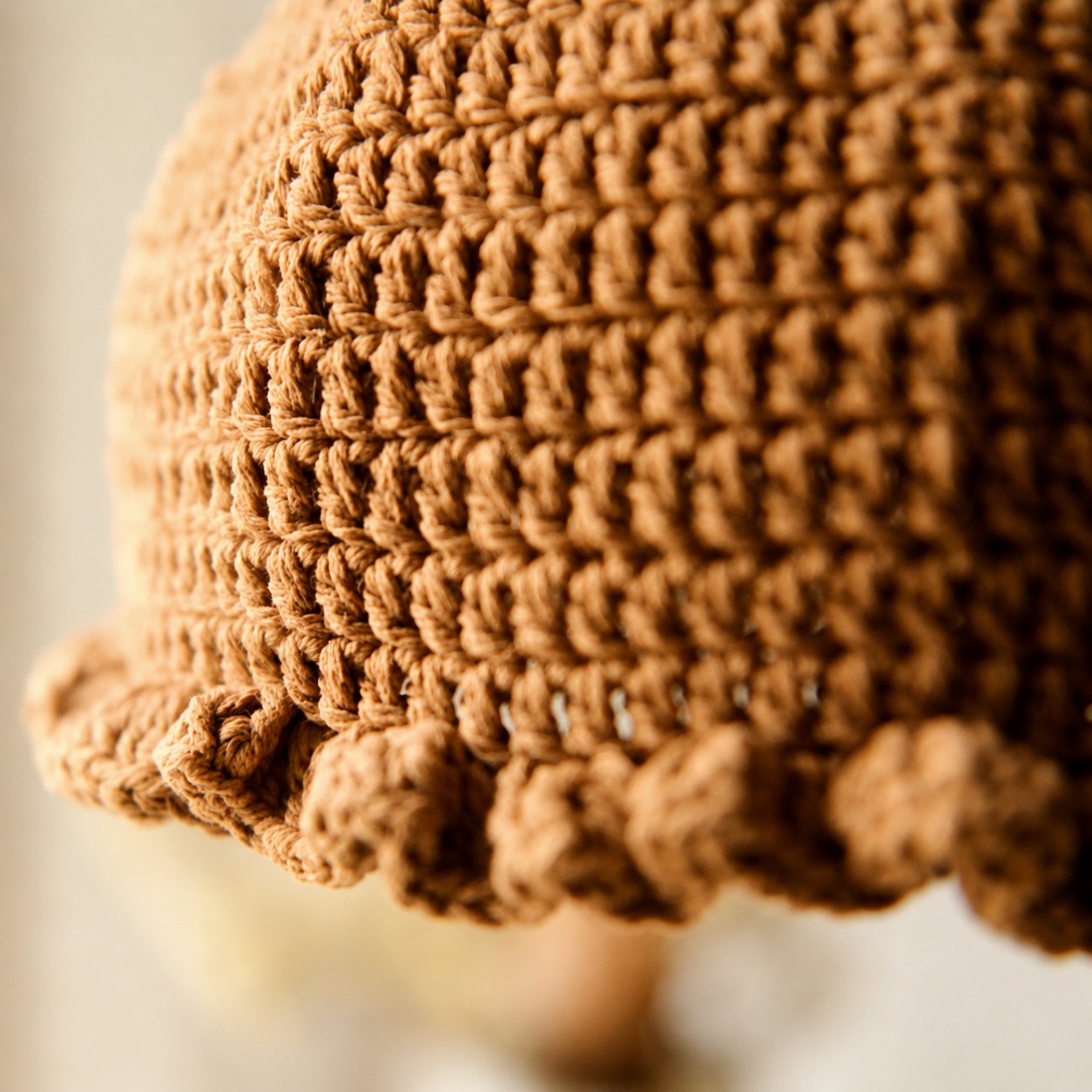 Close view of woven shade and scalloped lower edge