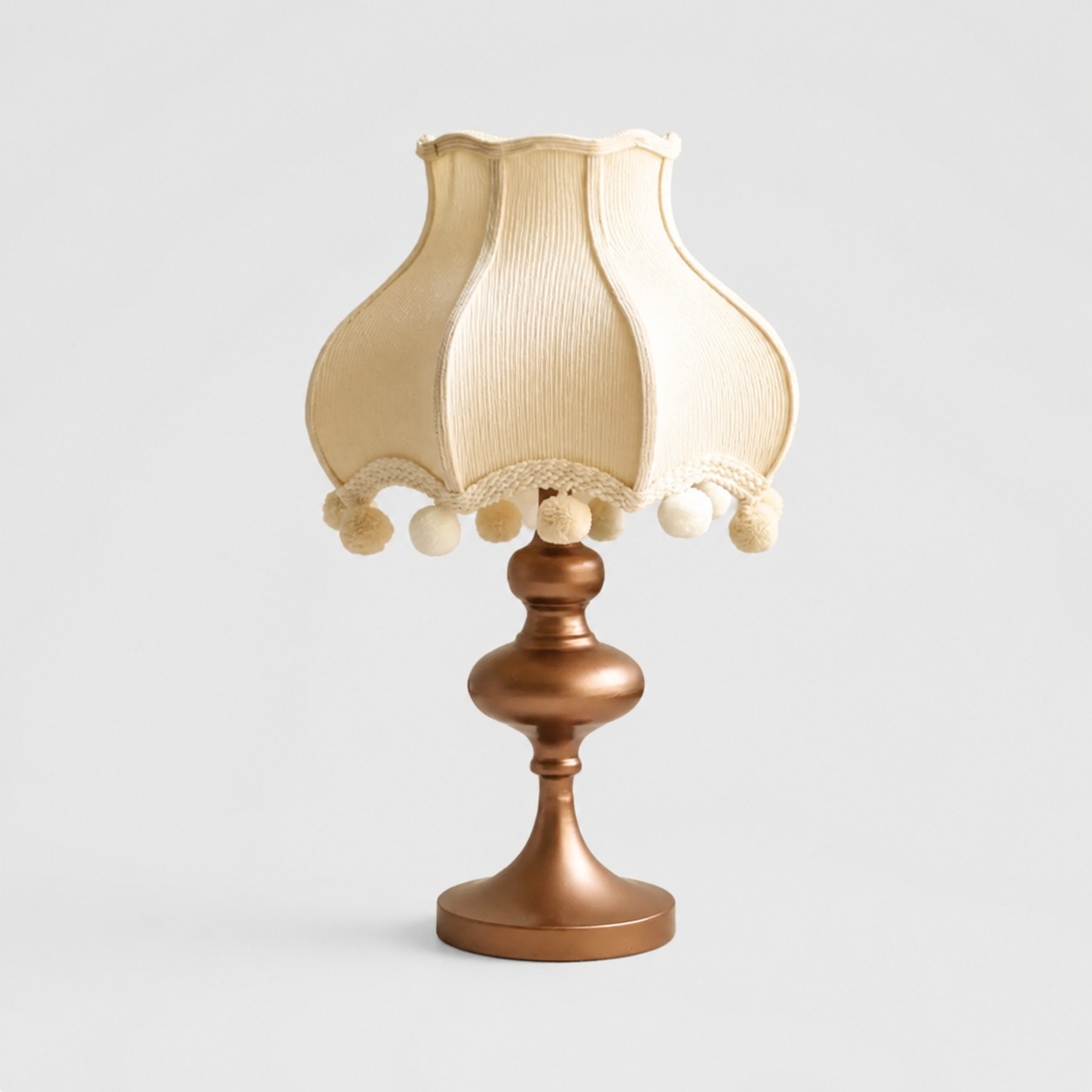 Cream fabric pom-pom table lamp with ivory trim
