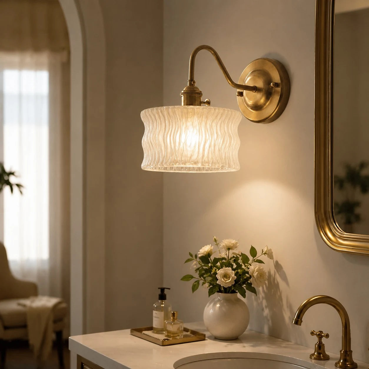 Frosted ripple glass wall sconce above a vanity counter