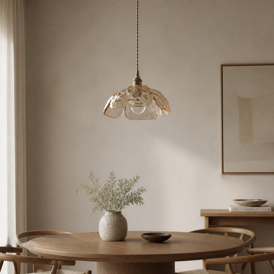 Clear walnut-accent pendant in a calm dining space
