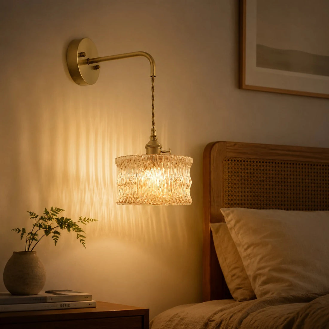 Ripple glass wall light beside a rattan headboard