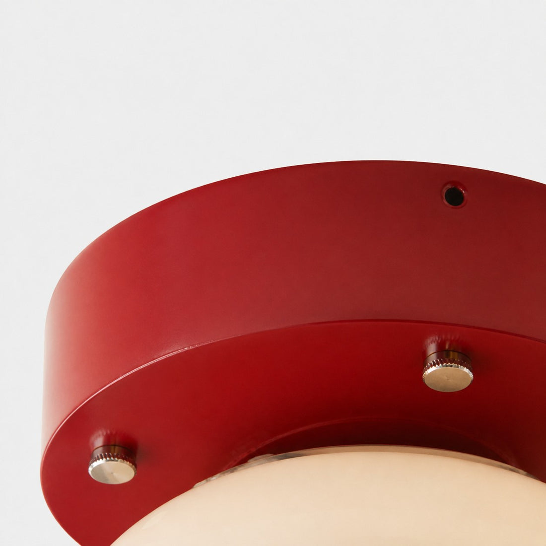 Close-up of red iron ceiling plate and metal fasteners