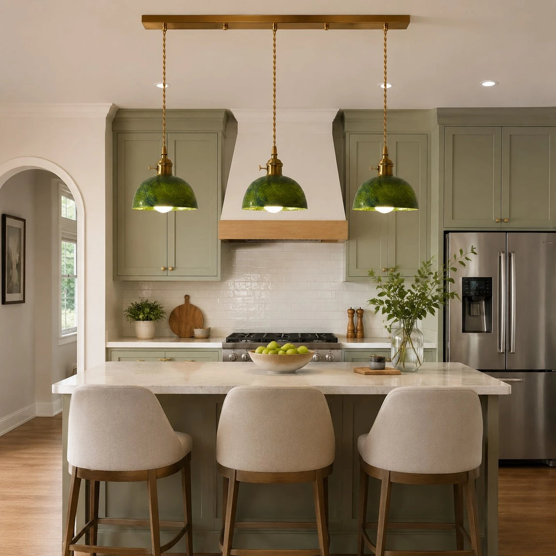 Linear canopy jade pendant lights over a kitchen island