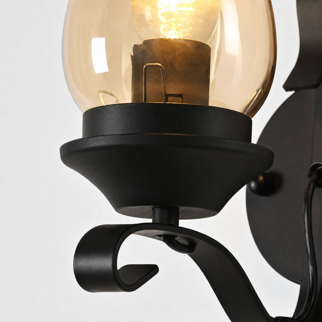 Close view of amber glass shade and E27 socket area