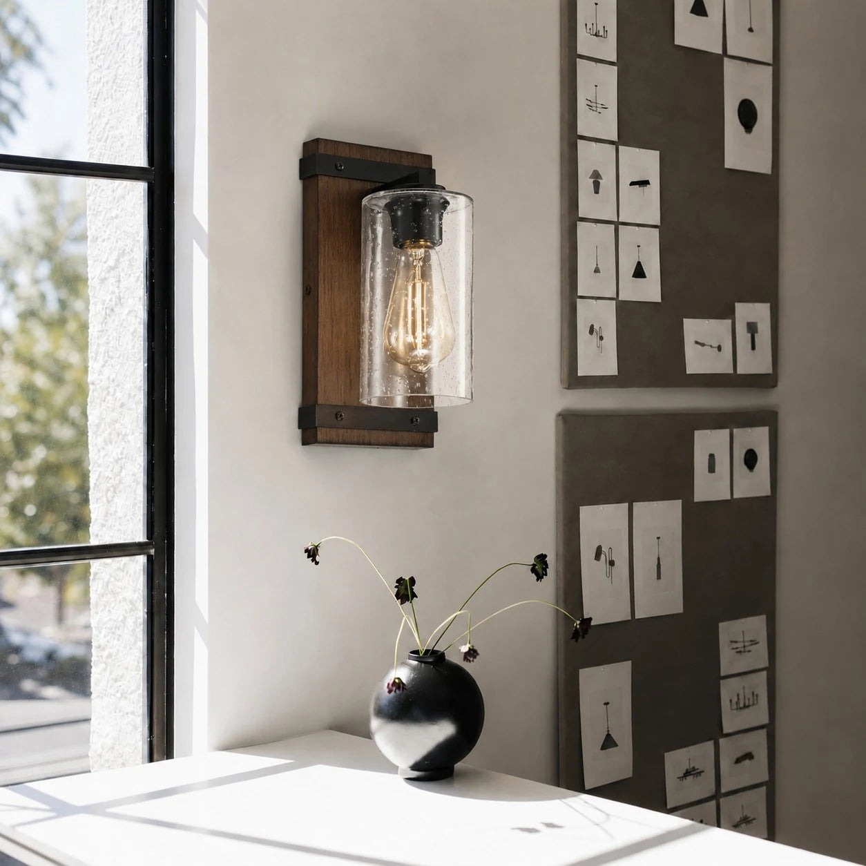 Wall sconce lighting a reading nook near a window