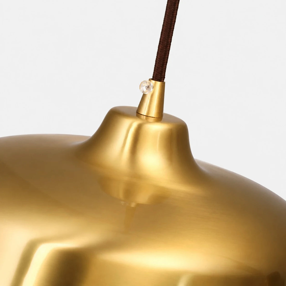 Close view of the bright brass surface and cord connection