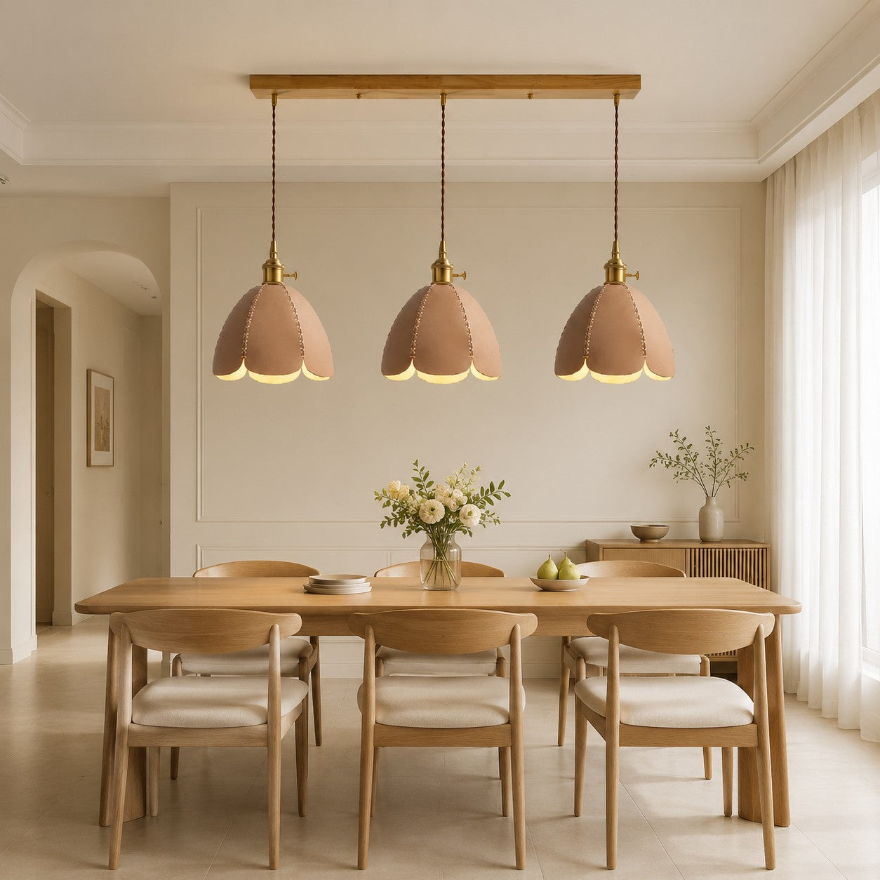 Three natural leather pendant lights in a light dining room