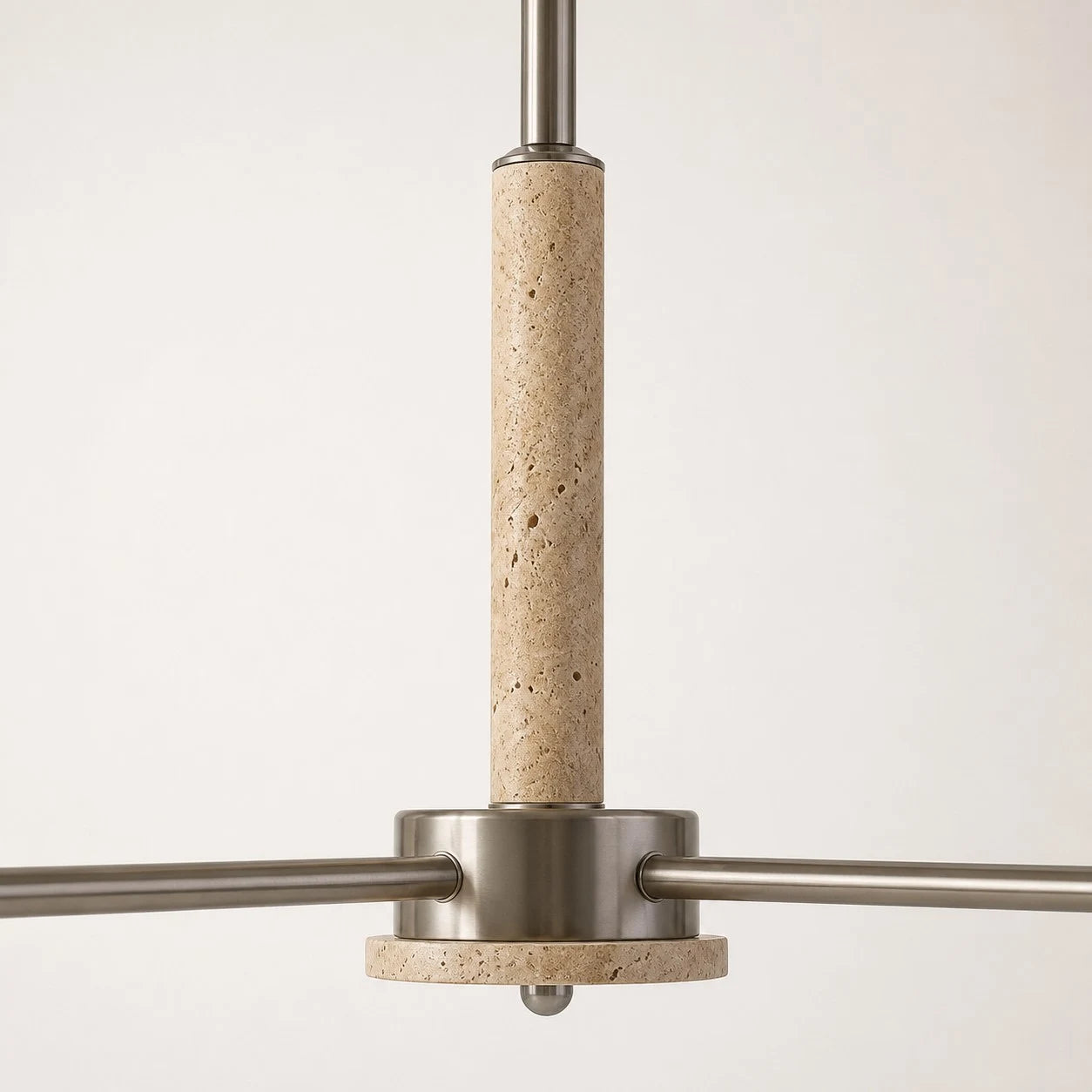 Close view of the travertine center column and metal arms