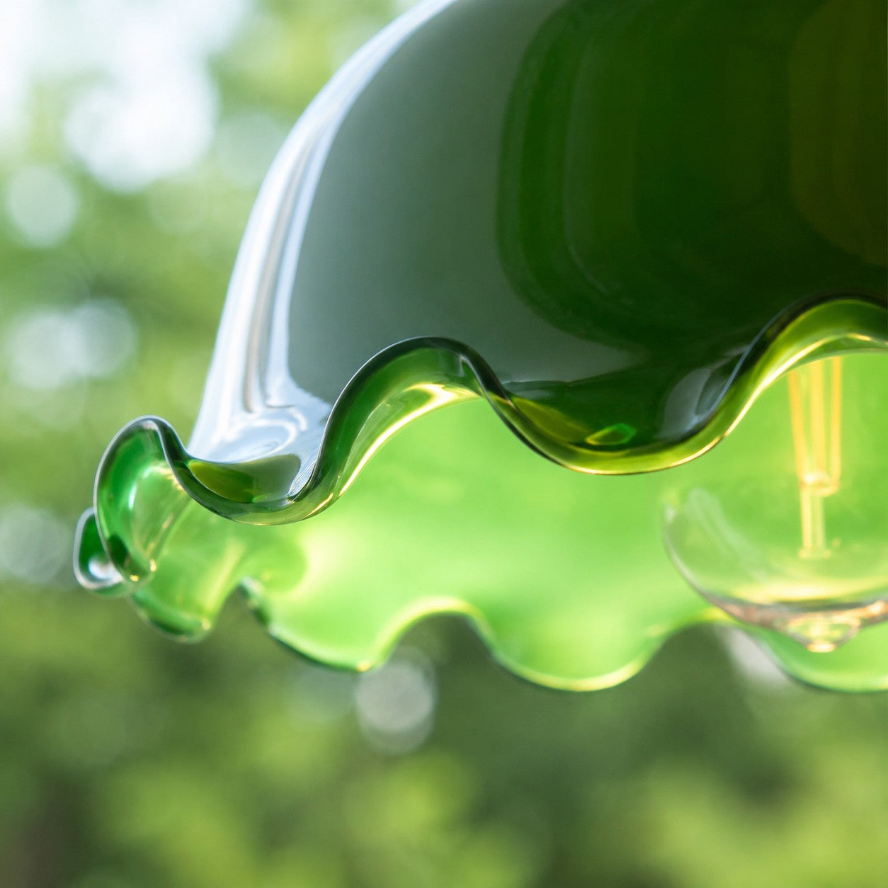 Lit wavy green glass shade edge detail