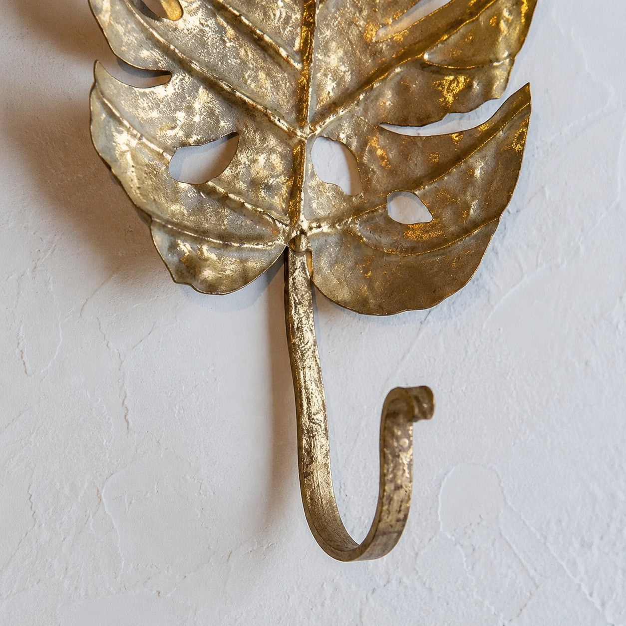 Curved iron hook and leaf joint detail