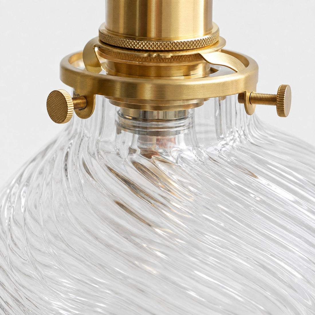 Close view of clear ribbed glass and brass connection