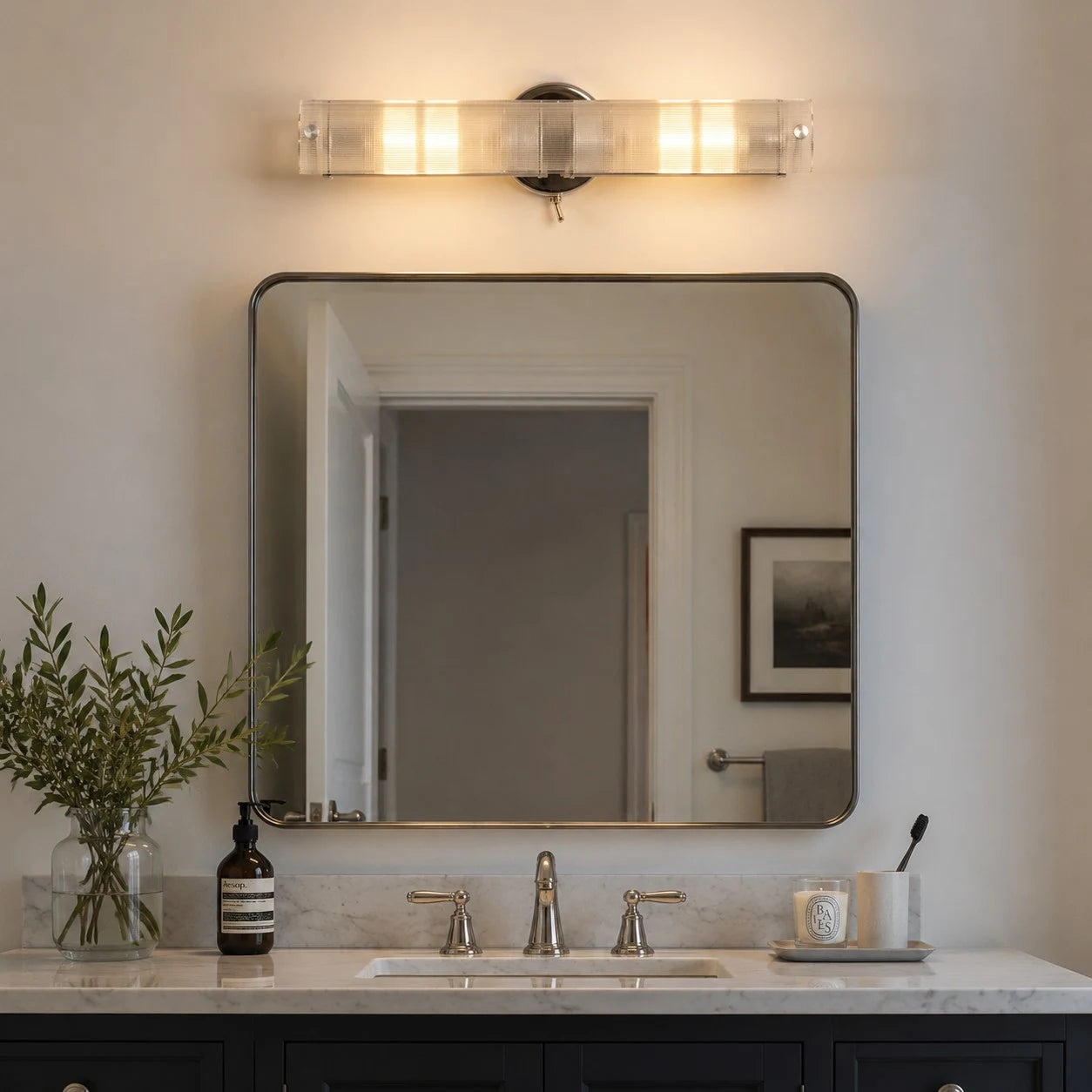 Double glass wall light above a bathroom mirror