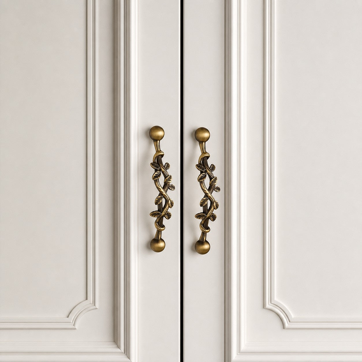 Pair of leaf brass cabinet pulls installed on double doors