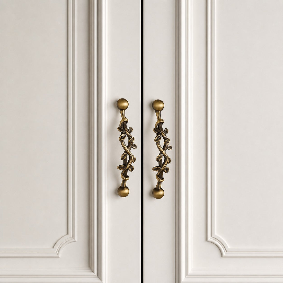 Pair of leaf brass cabinet pulls installed on double doors