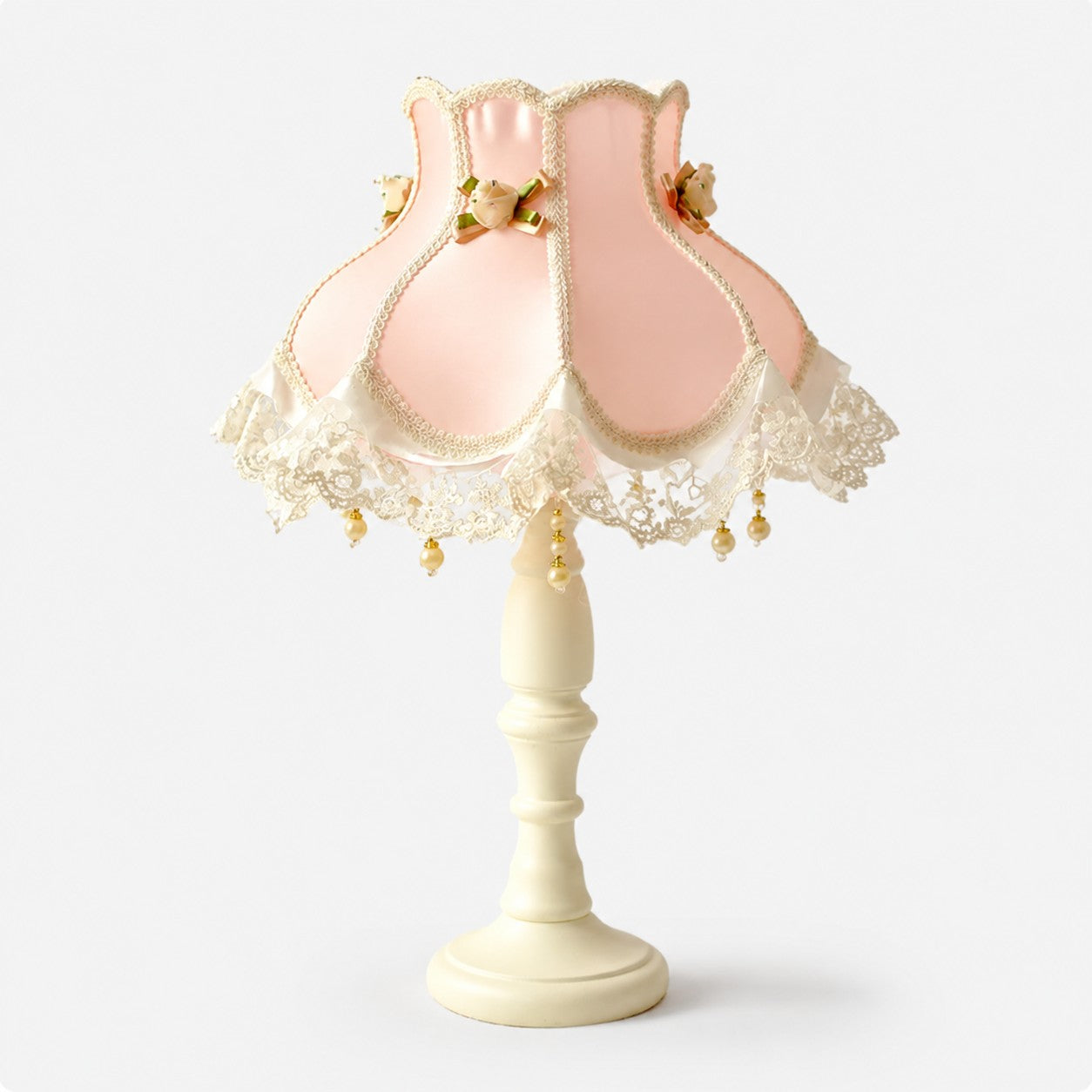 Blush pink satin lace table lamp on a light background