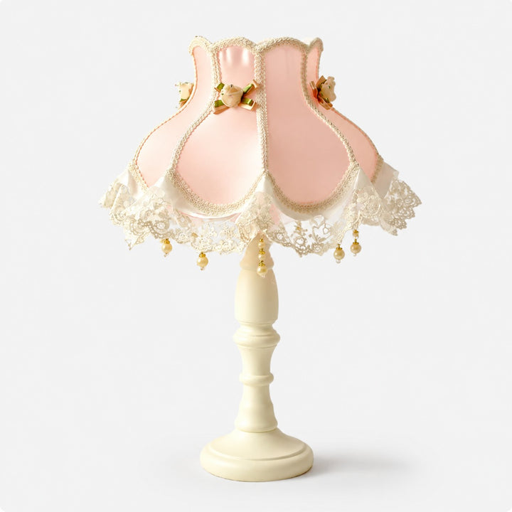 Blush pink satin lace table lamp on a light background