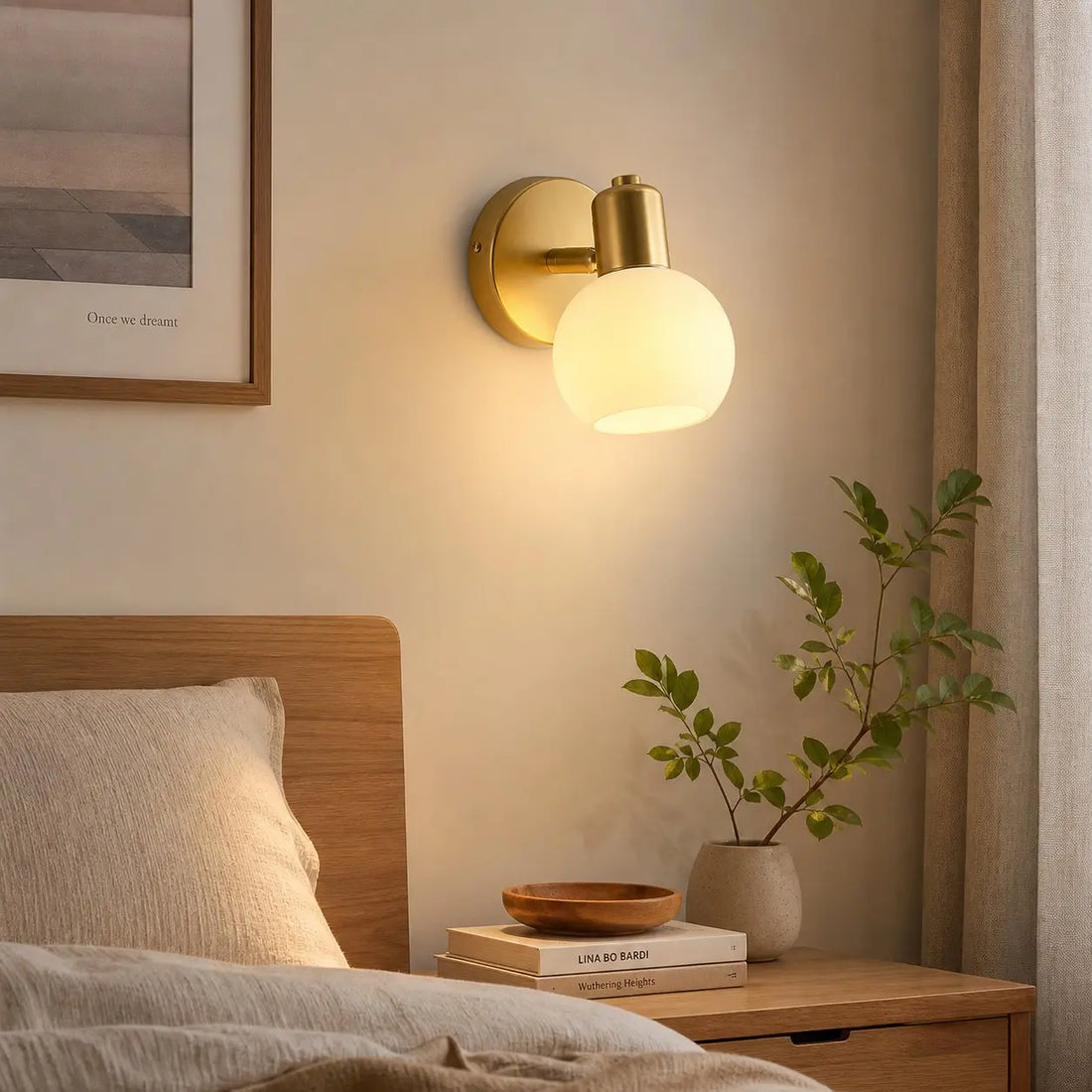 Single-light wall sconce beside a bed