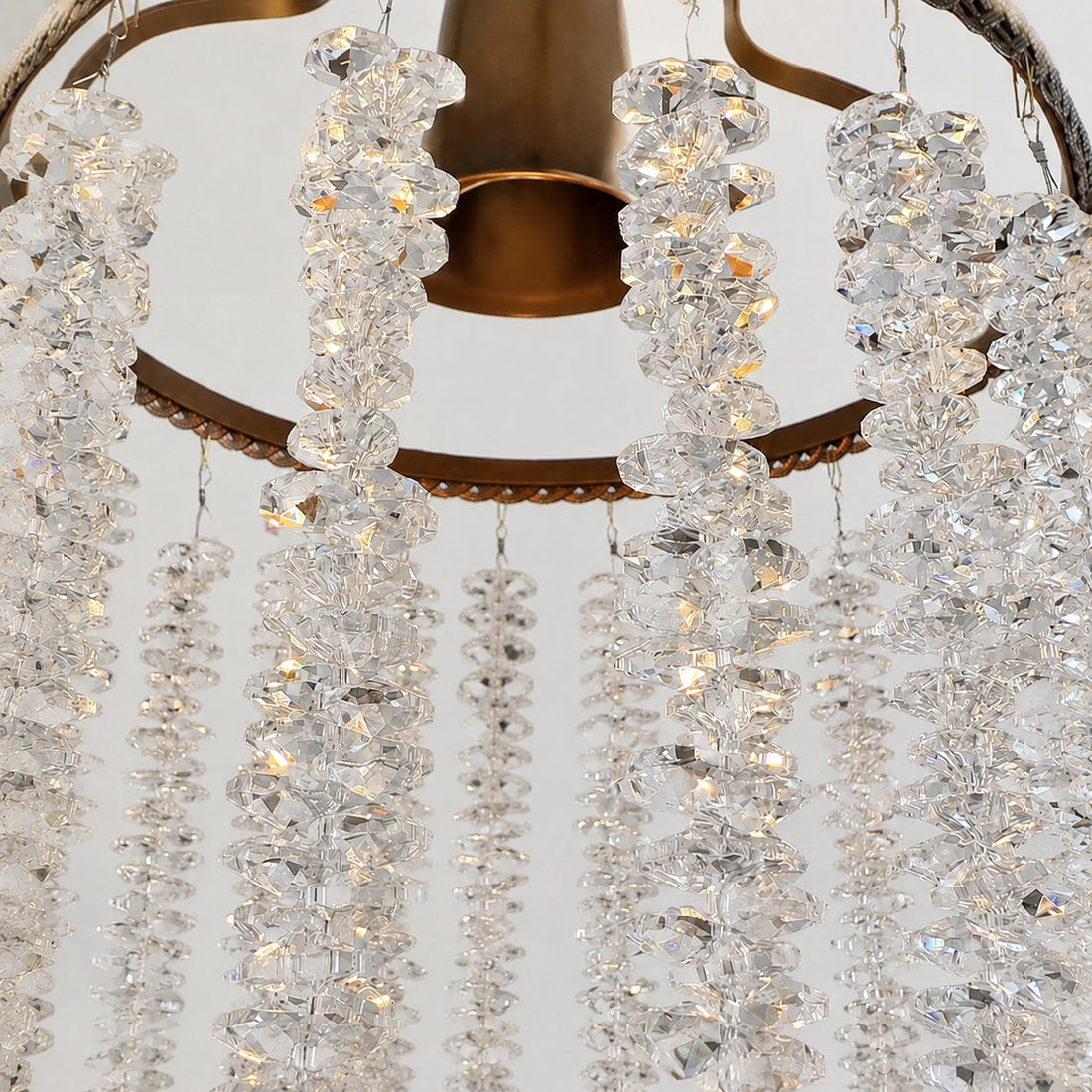 Close view of clear crystal fringe suspended from the metal frame