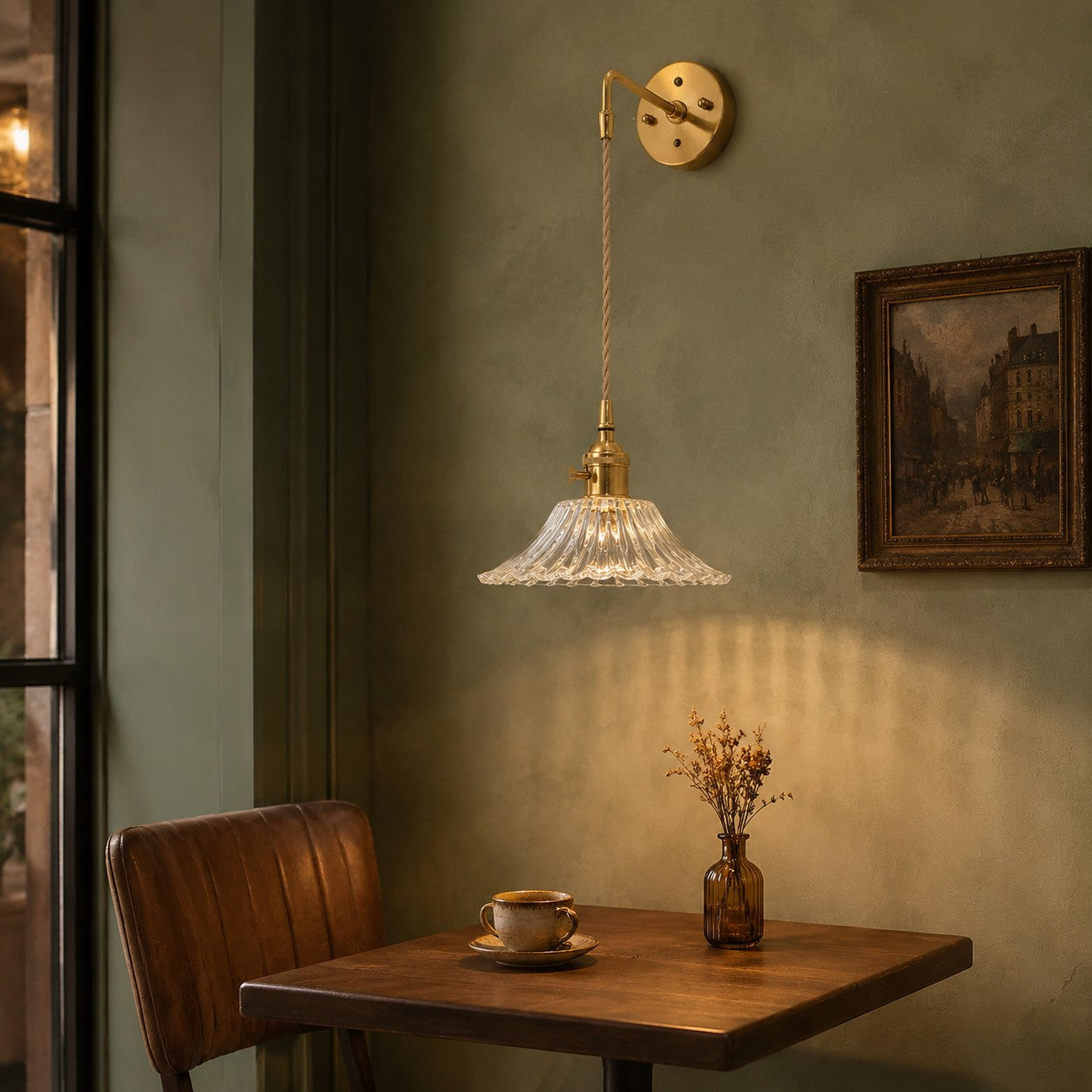 Brass and clear glass wall light in a calm living room corner