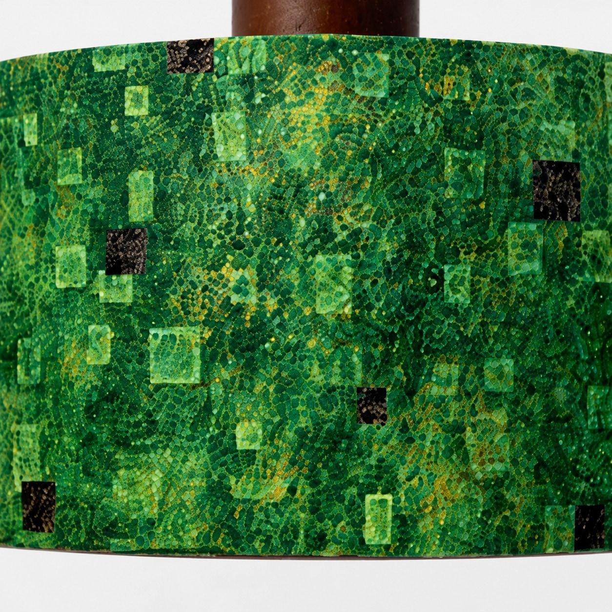 Close view of green gilded patterned fabric shade
