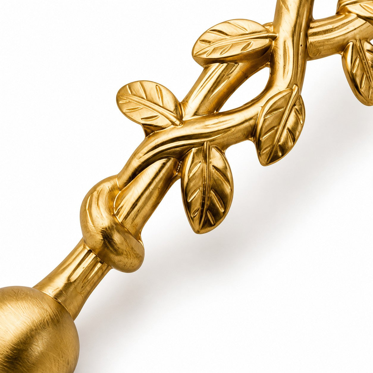 Brushed brass leaf detail on the cabinet pull