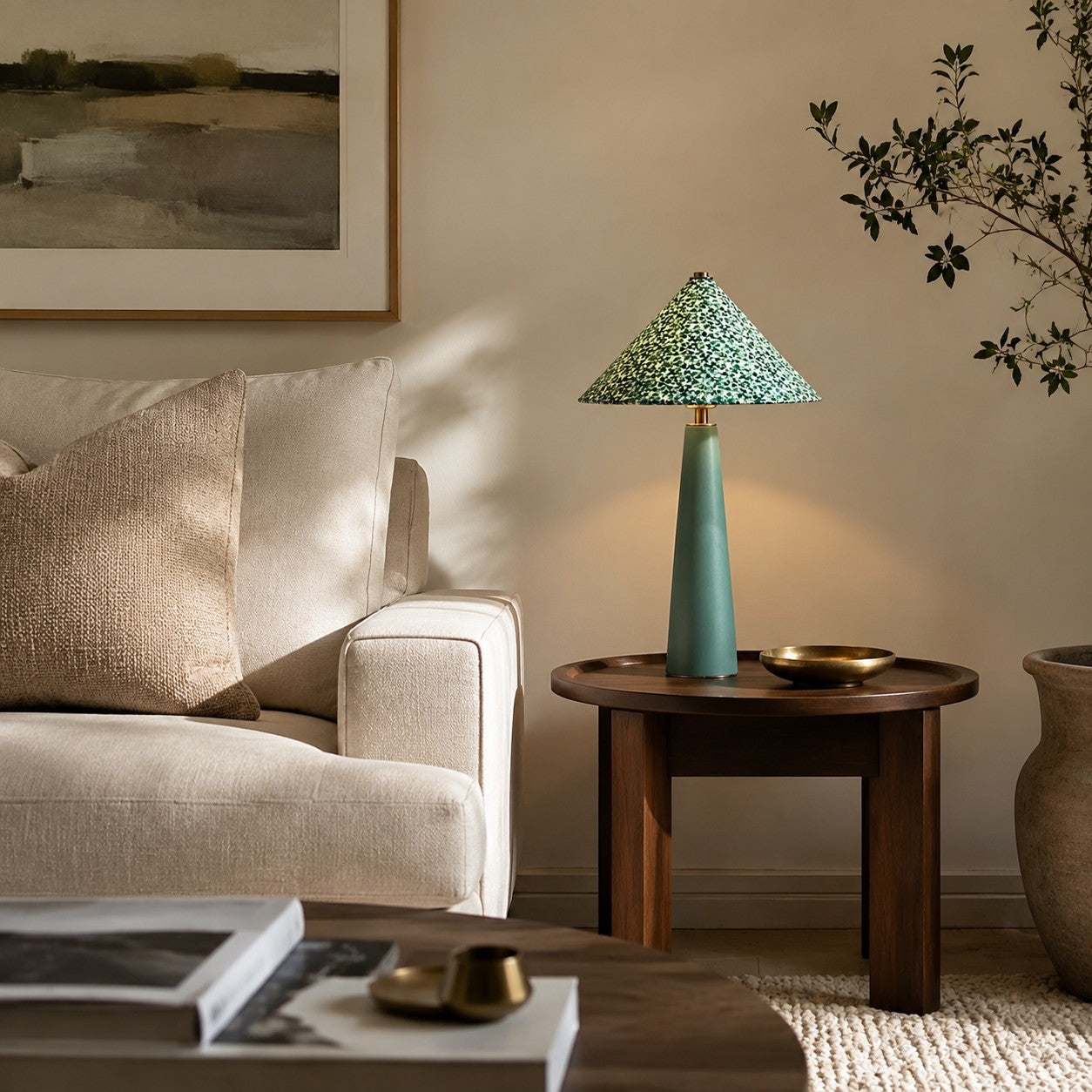 Green floral table lamp beside a sofa