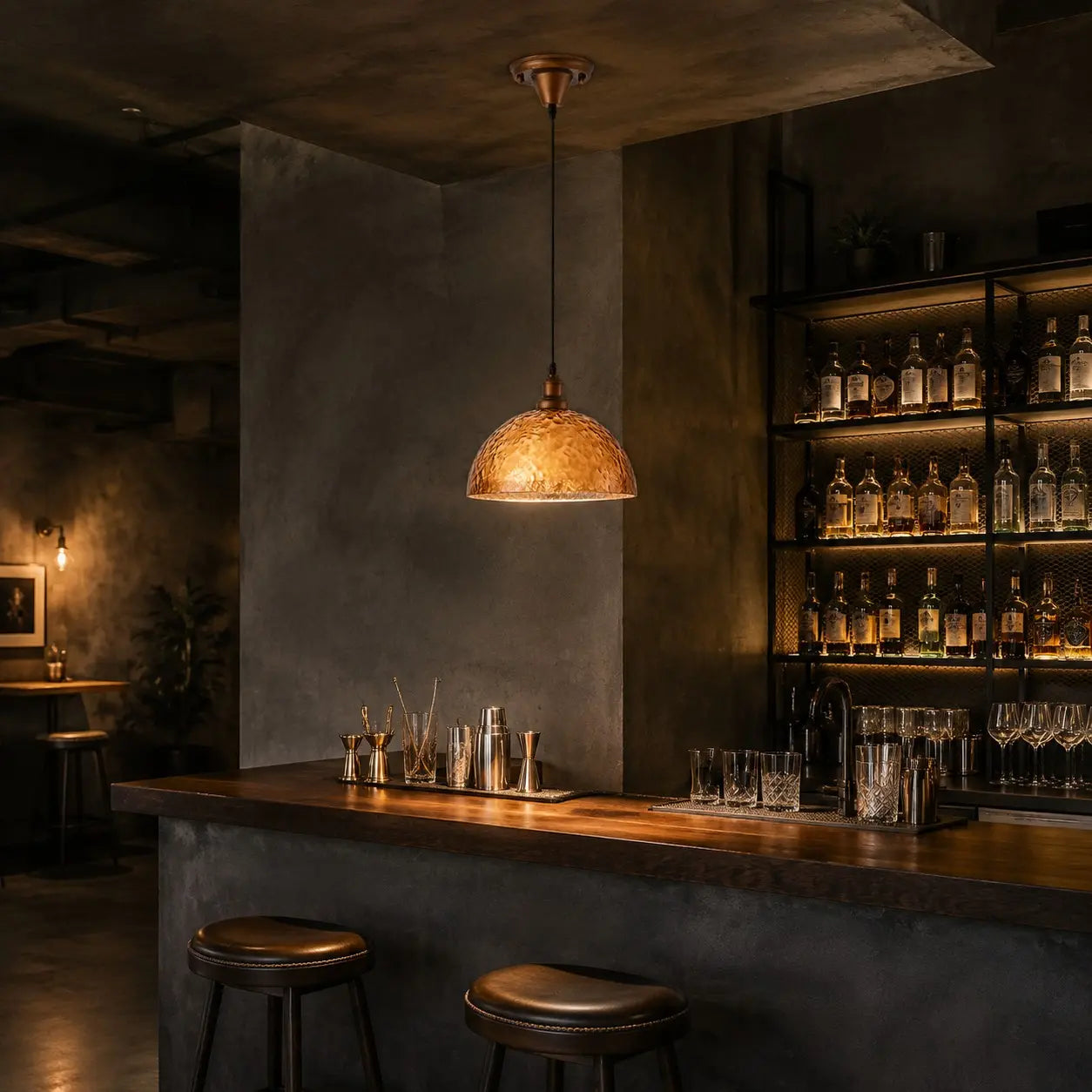 Amber pendant light above a home bar