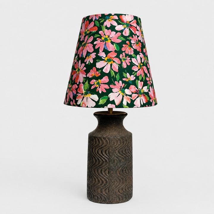 Front view of floral fabric table lamp with textured dark ceramic base